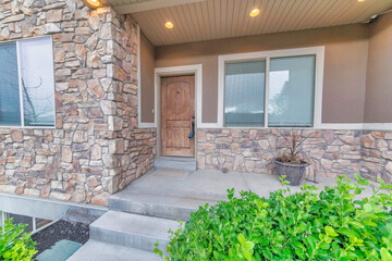 Exterior of a house with brown and stone veneer walls