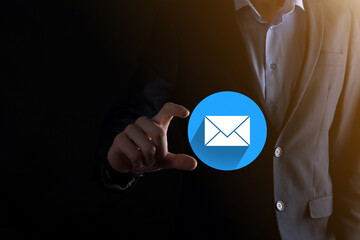 Businessman hand holding letter icon,email icons.Contact us by newsletter email and protect your...