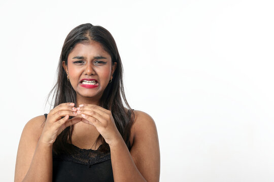 Young attractive Asian Indian woman pose face body expression mode emotion on white background hand eating sandwich burger bite bad disgusting