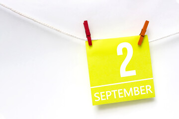 September 2nd. Day 2 of month, Calendar date. Paper cards with calendar day hanging rope with clothespins on white background. Autumn month, day of the year concept.