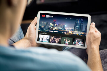 Movie and series stream VOD service in tablet. Watching on demand tv show or film online. Man...
