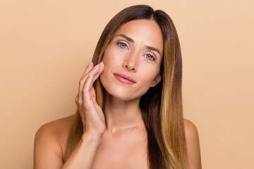 Portrait of nice-looking cute long-haired woman touching soft fresh skin lifting uplift effect isolated over beige pastel color background