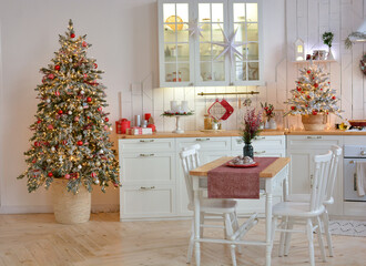 Interior of a light white сhristmas kitchen with red decor elements in the Scandinavian style. Christmas decorations. Breakfast