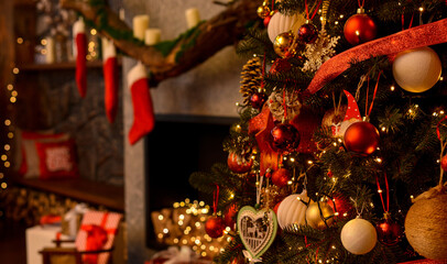 Christmas room. Beautifully decorated Christmas tree on the background of the fireplace, santa socks, boxes with gifts.