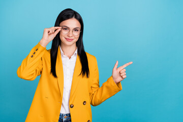 Photo of positive joyful attractive business lady smile point finger empty space isolated on blue color background
