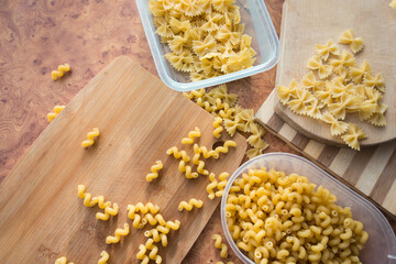 Different types of pasta Cellentani, Tortiglioni, Farfalle, spaghetti are often used in the kitchen for cooking.