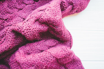 Soft texture of dark sweater on white wood background in autumn