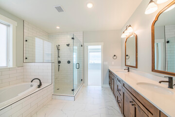 Contemporary master bathroom interior with marble tile flooring and a view of a room