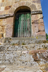 Fototapeta na wymiar Bell tower of the cave church of Olleros de Pisuerga: In honor of Saints Justo and Pastor, it is a hermitage whose origins date back to the 7th century,