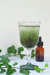 Natural liquid chlorophyll. Chlorophyll drops in a glass of water