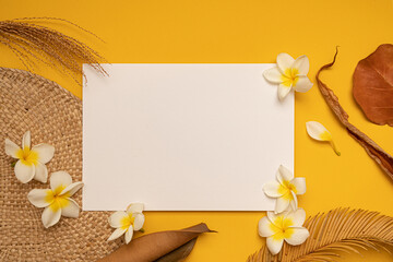 Styled summer mockup. Blank greeting and invitation card. Dried tropical leaves with empty space.