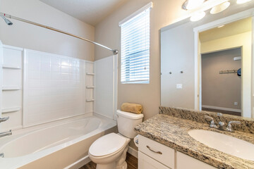 Bathroom interior with window and acrylic bathtub wall kit