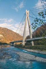 cable-stayed bridge in the mountains above the river