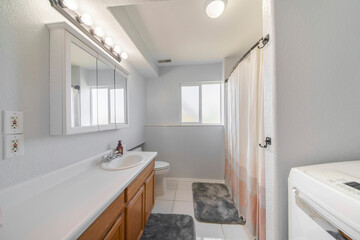 Fototapeta na wymiar Interior of a bathroom with window and laundry units