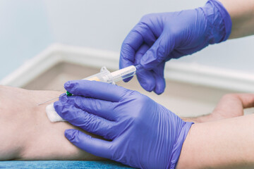 Nurse taking a blood sample, close up