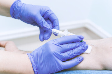 Nurse taking a blood sample, close up