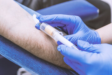 Nurse taking a blood sample, close up