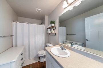 Interior of a bathroom with white floor cabinet and vanity sink