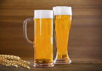 mug of beer, wheat ears, hops on a wooden background