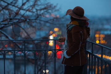 stylish woman outside in city park in winter