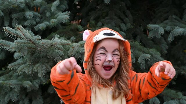 cute happy girl dancing and smiling in tiger costume with gift concept of the year of the tiger 2022. High quality 4k footage