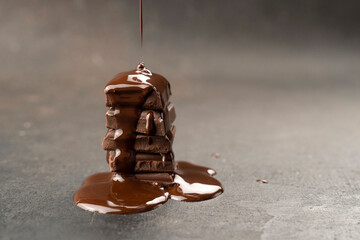 melted chocolate pouring into a piece. Chocolate tower pieces. recipe Cooking handmade chocolate bar, dessert, candies. Confectionery covered with chocolate topping
