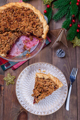 Traditional American apple cranberry pie, topped with crumbled dough and pecan, vertical, top view
