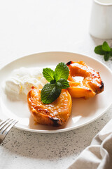 Apple quince baked with honey on a white plate with ice cream. Healthy vegetarian dessert.
