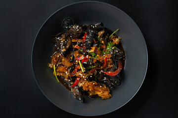 asian salad with asparagus on a black background
