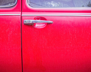classic car shiny handle and red door partial view, space for your text