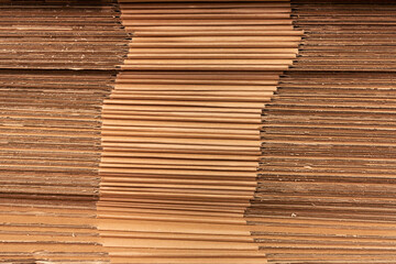A stack of folded cardboard boxes. The packaging is ready for use in production.