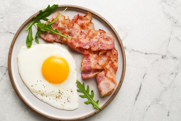English breakfast. Egg and fried bacon.  Serving breakfast on a marble table. Fried egg.