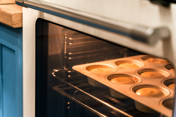 Cupcakes are prepared in the oven in the kitchen at home