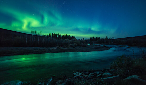 The aurora borealis or northern lights appear in the fall over the Chatanika River near Fairbanks, Alaska. 