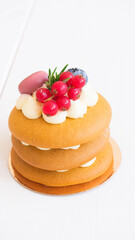 Cake or small honey cake decorated with berries
