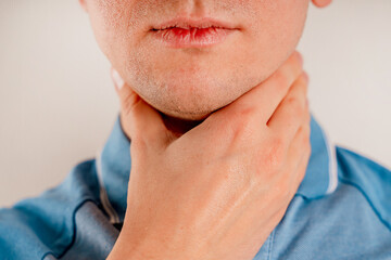  A man checks the lymph nodes on his neck.