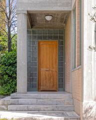 modern design house entrance with glass blocks and solid wood door, Europe