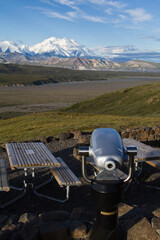 A telescope and picnic table set up for visitors at Eielson Visitor Center with Denali (Mt....