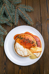 Brie cheese grilled on a wooden table. Christmas dinner
