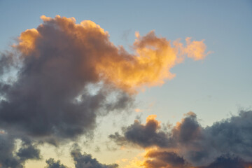 Colorful clouds in the setting sky as a background.