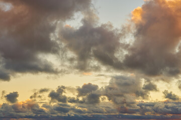 Colorful clouds in the setting sky as a background.