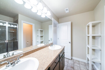 Bathroom interior with rough tile floors and corner wooden shelves