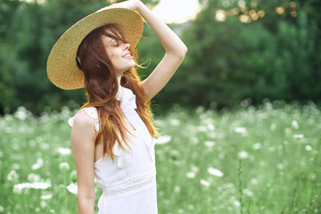 cheerful woman in a white dress on nature flowers walk