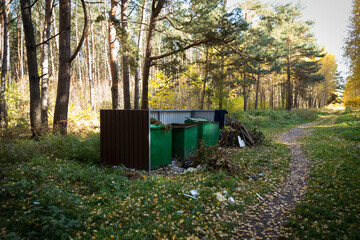 Greenery metal containers for collecting garbage in the forest. Waste collection and ecology.