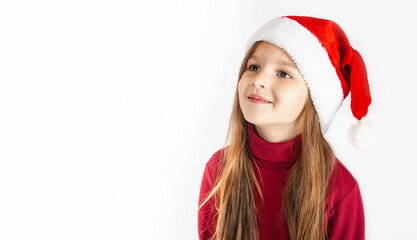 Portrait of a cheerful little girl 5 years old wears Santa hat, isolated on white background. copy space. Holiday, Christmas, New year concept.