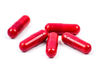 Red pills on white background