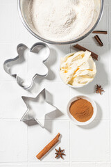 Ingredients for Christmas gingerbread with cinnamon, anise, flour on a white table