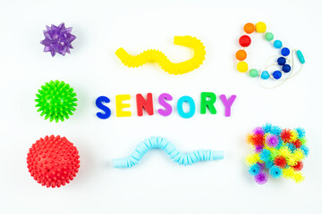 Sensory word and colorful balls that magically bunch. Sensory training, sensory integration, dysfunction and processing disorder. Sensory toy, creativity, fine motor skills, occupational therapy - obrazy, fototapety, plakaty