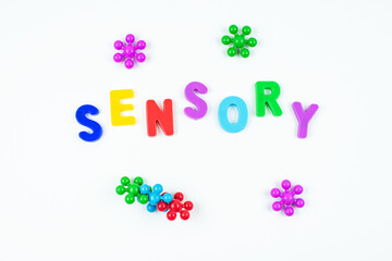 Sensory word and colorful balls that magically bunch. Sensory training, sensory integration, dysfunction and processing disorder. Sensory toy, creativity, fine motor skills, occupational therapy