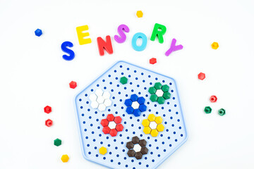 Sensory word and mosaic toy. Sensory training, sensory integration, dysfunction and processing disorder. Sensory toy, creativity, fine motor skills, occupational therapy